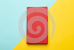 Red box product packaging  on yellow half blue background. Flat lay Top view.