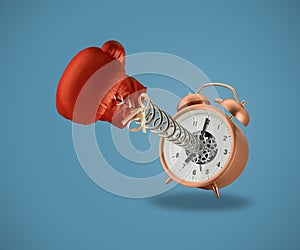 Red boxing glove coming out of alarm clock