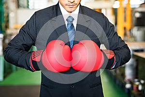 Red boxing gloves of factory businessman