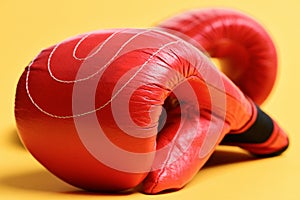 Red boxing gloves on yellow background - Flat lay. Sports and boxing concept.