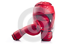 Red boxing head guard and a pair of red boxing gloves