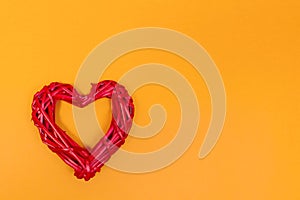 Red braided heart on an orange background