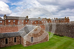 Red brick barracks in historical Fort George, Scotland with a ditch