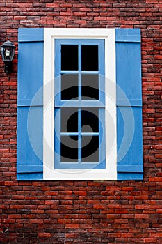 Red brick with blue and white window