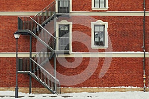 Red brick building. Staircase, the facade of the building. fire exit.