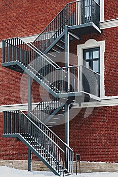 Red brick building. Staircase, the facade of the building. fire exit.