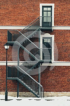 Red brick building. Staircase, the facade of the building. fire exit.