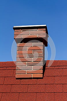 Red brick chimney on red roof