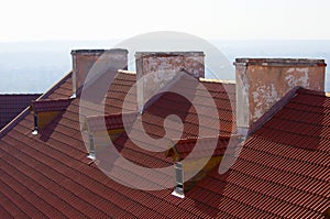 Red brick chimney on the roof of the house