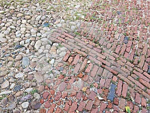 Red brick and cobblestone or stone street