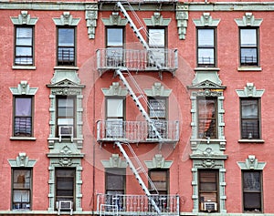 Red brick facade, and fire stairs. Harlem, NYC