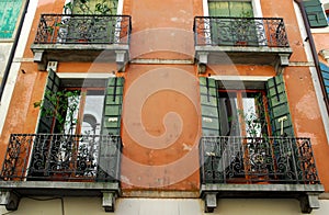 Red brick facade with four balconies of a house in Oderzo province of Treviso in the Veneto (Italy)