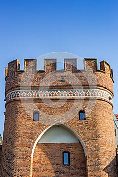 Red brick Mostowa city gate in Torun