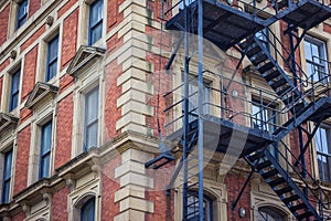 Red brick office or apartment building with metal fire escape.