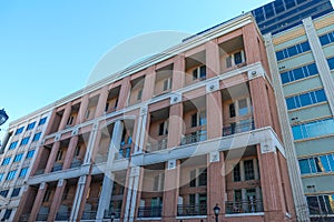 A red brick office building with recessed balconies with clear blue sky at Atlantic Station in downtown Atlanta photo