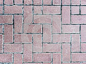 Red brick pavement texture in herringbone pattern, seamless 8k resolution surface background