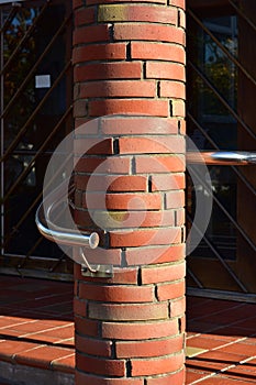 Red brick round pillar with railing