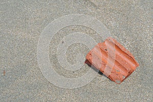 Red brick on sand