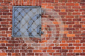 Red brick texture. Old brick wall background. Forged metal hatch installed into a brick wall