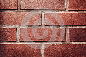 Red brick wall background. Texture of a stone wall. Close-up of bricks