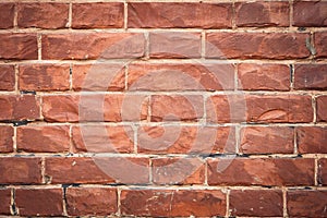 Red brick wall, bricks background, grunge texture. Decorative tile surface. Rough brickwork. Brown wallpaper, design in rustic