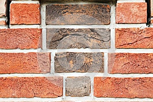 Red brick wall from bricks. Geometric background image from brown bricks. Compound with smooth brickwork