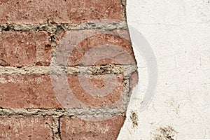 Red brick wall and half-ruined white stucco, architecture abstract background