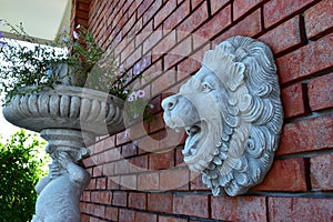 Red Brick wall with the Lion Face Sculpture