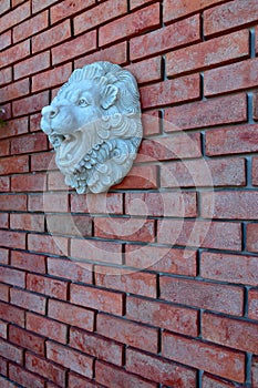 Red Brick wall with the Lion Face Sculpture