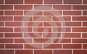 Red brick wall made of smooth brick. Seamless smooth brick wall texture with vignetted corners. Brick wall background, copy space