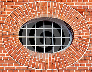 Red brick wall with an oval Window