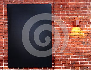 Red brick wall with black board hanging on it