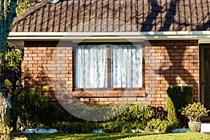 red brick wall of small rural house with window