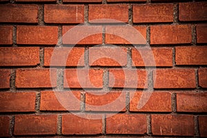 Red brick wall texture with dark vignette in corners