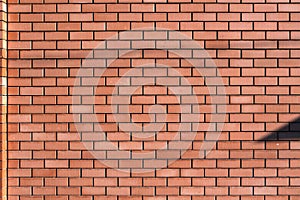 Red brick wall texture grunge background for interior and home design. Wide panoramic photo of the building with good detail. Abst