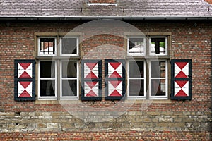 Red brick wall with two windows