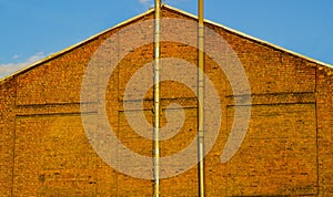 Red brick wall with vent pipes, texture background