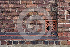 Red brick wall with ventilation brick