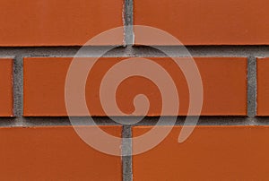 Old wall of red briks tiled background, regular block texture.