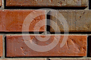 Red Brick wall was assembled with a cement and manpower - close up photo. Background picture.