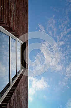 Red brick wall and window in sky