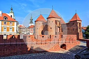 Red brick walls and towers of Warsaw Barbican, Poland photo