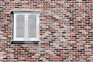 Red brick and white shuttered rectangle window