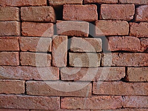 Red bricks are arranged to fortify the sand photo