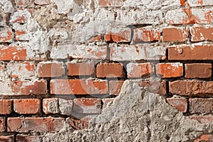 Red bricks dirty wall surface with marks of concrete and white paint texture macro