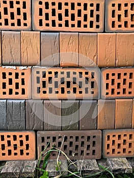 Red bricks with holes background. Storage brickwork product