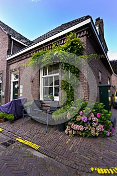 Red bricks house facade with window bench and flowers Naarden Netherland