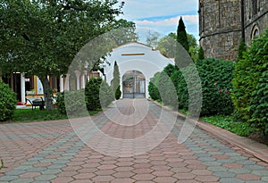 Red bricks sidewalk leading to gate in Serbian monastery