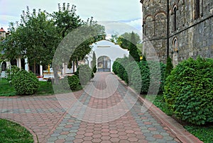 Red bricks sidewalk leading to gate in Serbian monastery
