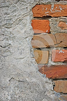 Red bricks stone wall background closeup, cracked ruined stucco, vertical plastered grunge grey beige stonewall limestone pattern